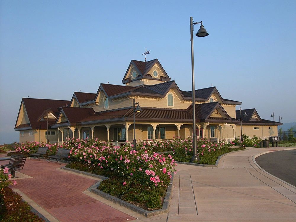 Large timber-style building with metal roofs and a central tower