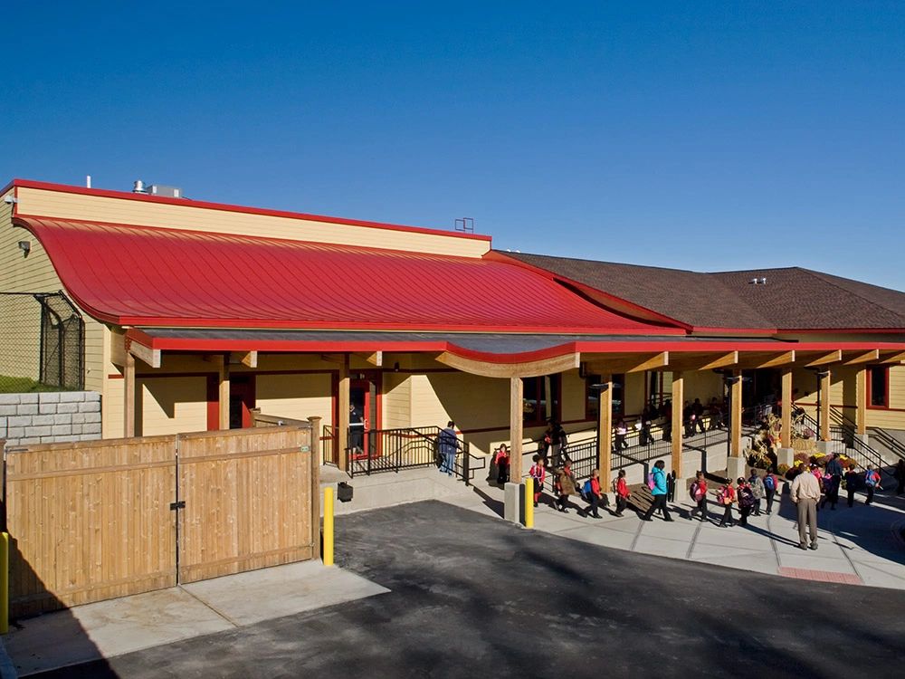 Red metal roof over a covered commercial walkway